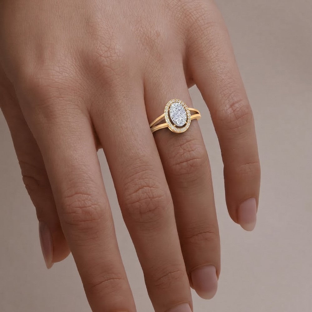 Gold ring with a diamond on a person's finger against a neutral background