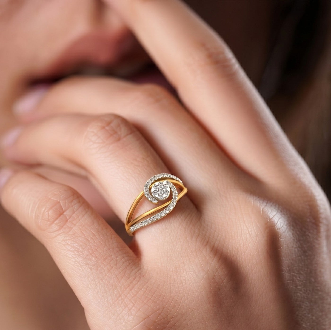 Close-up of a hand wearing a gold and diamond ring.