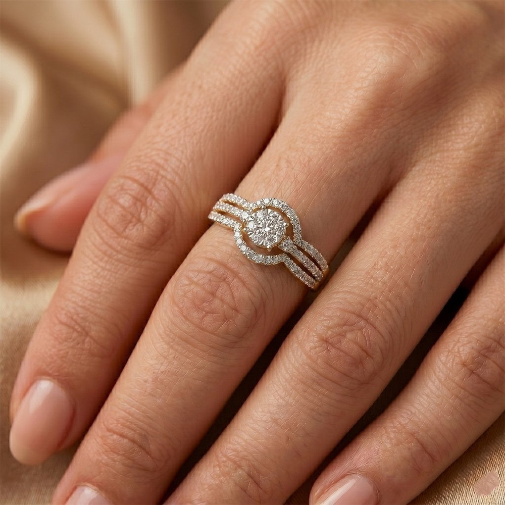 Gold ring with a diamond on a hand against a beige fabric background.