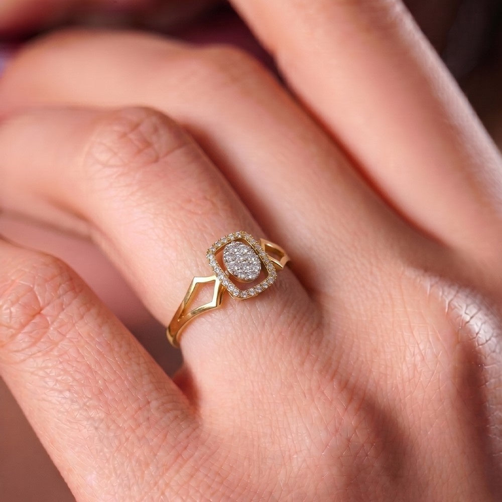 Gold ring with a diamond on a person's finger.