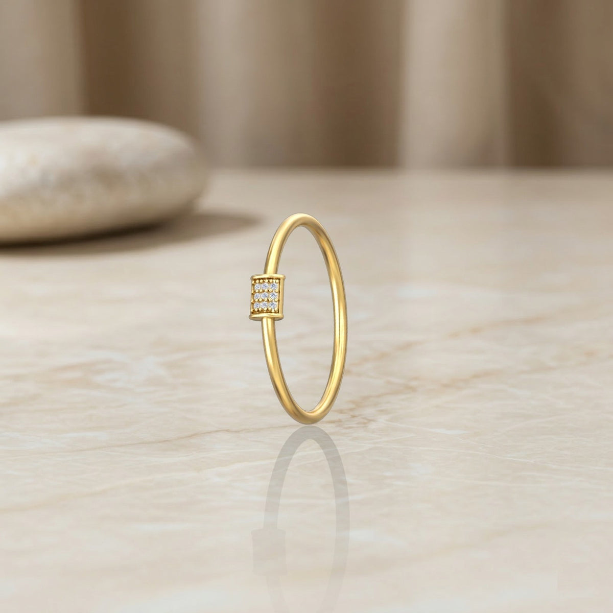 Gold ring with small diamonds on a light wooden surface