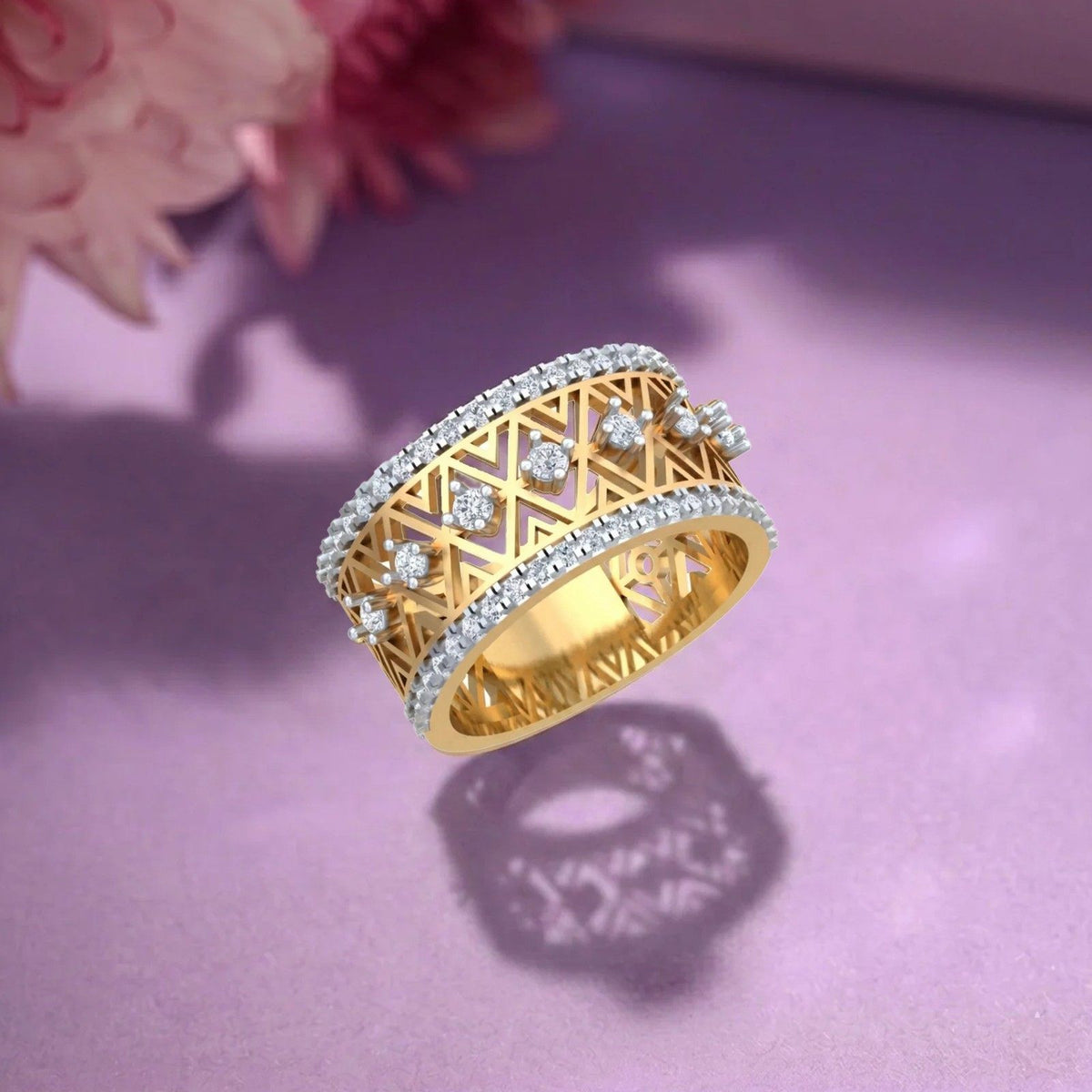 Gold ring with diamond accents on a purple surface