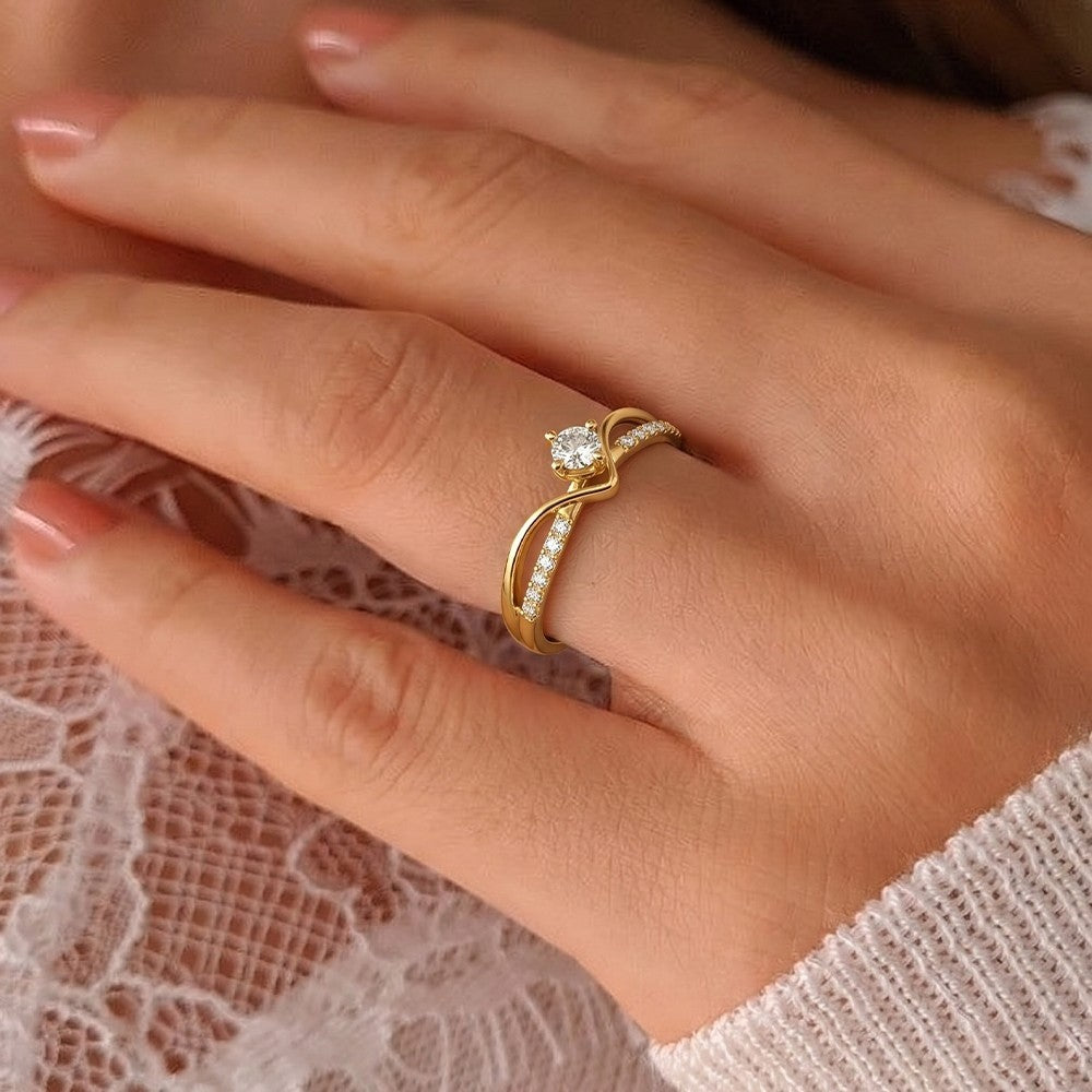 Gold ring with a diamond on a hand against a lace background