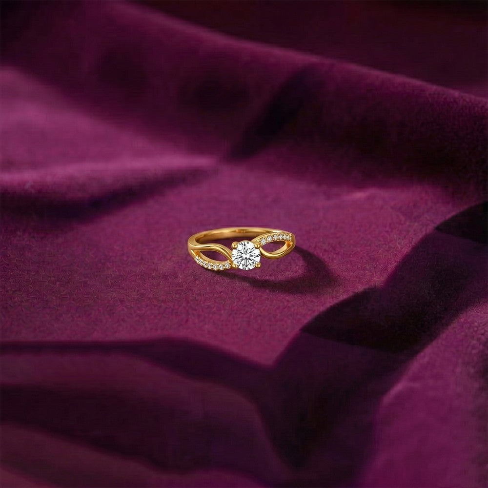 Gold ring with a diamond on a purple fabric background