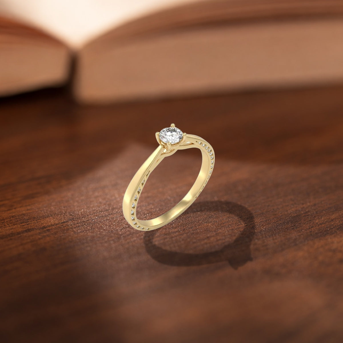 Gold and diamond solitaire women's ring on a wooden surface.