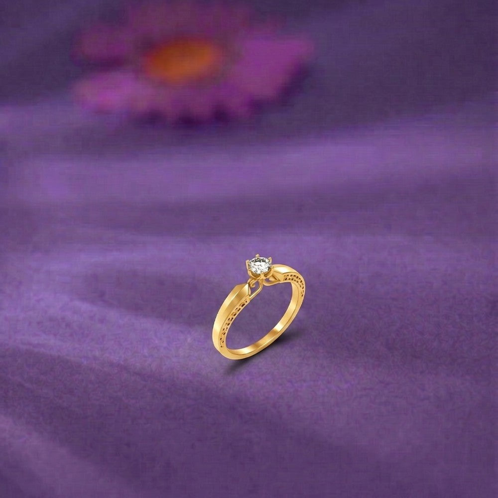 Gold and diamond with solitaire on a blue surface.