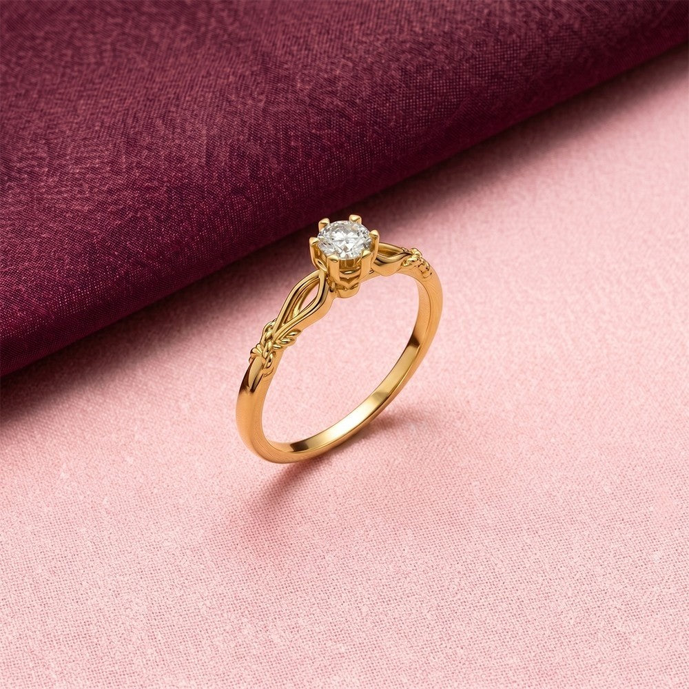 Gold ring with a diamond on a pink fabric background