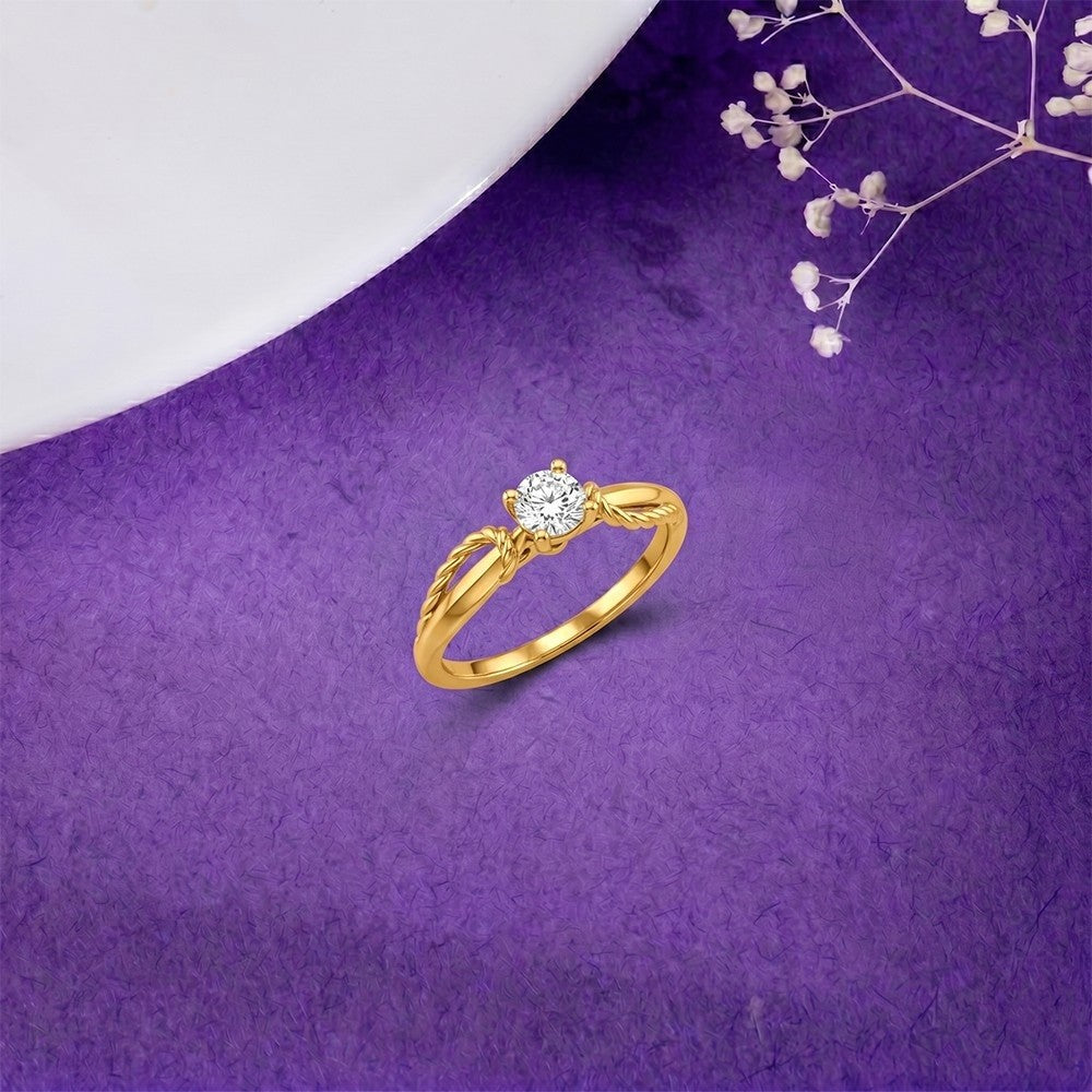 Gold ring with a diamond on a purple background