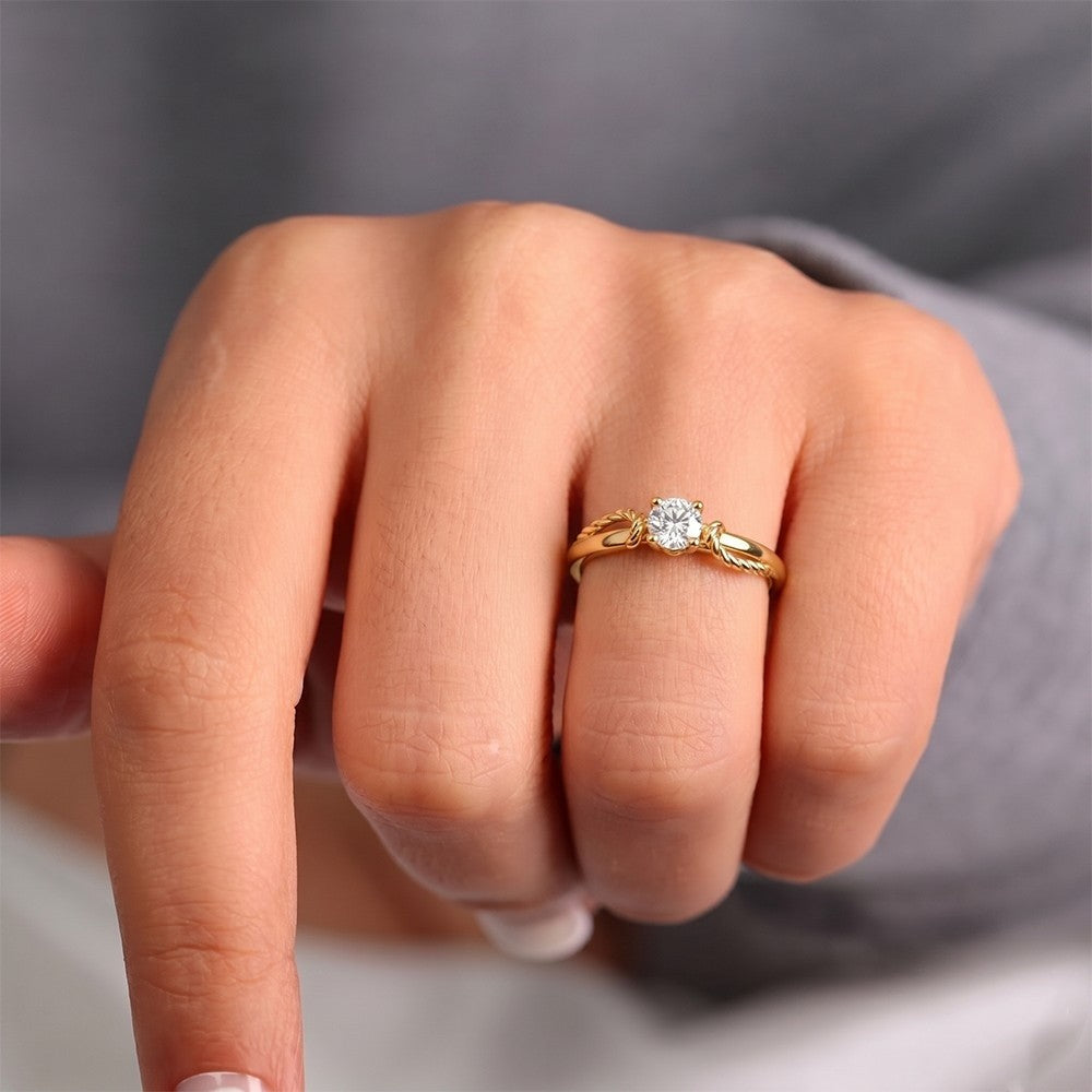 Gold ring with a diamond on a purple background