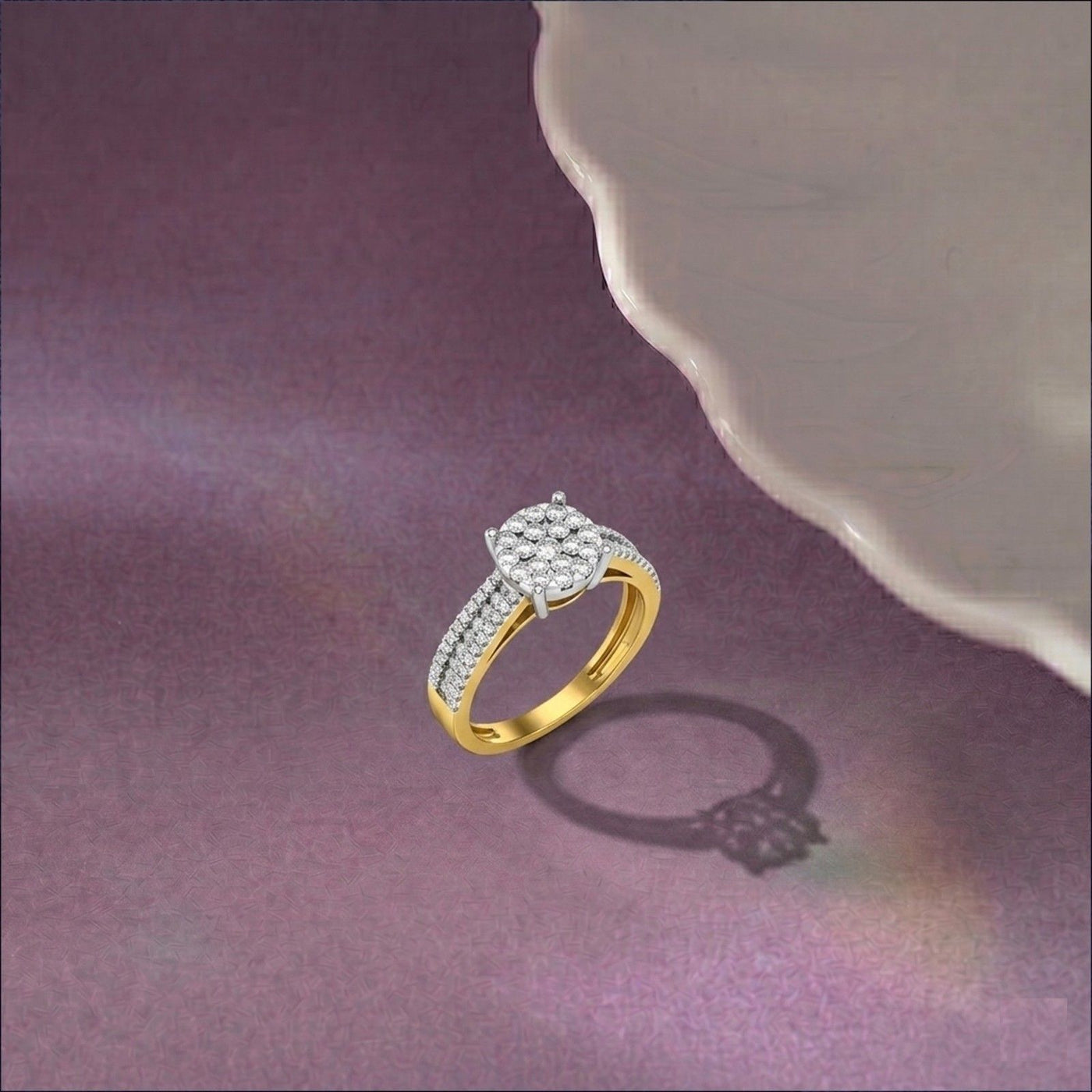 A gold ring with a diamond-encrusted cluster, displayed on a textured purple surface.