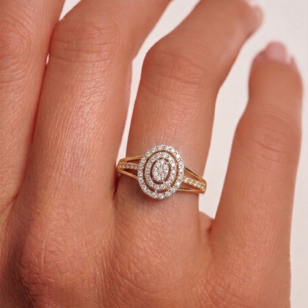 Gold ring with diamonds on a hand against a white background.