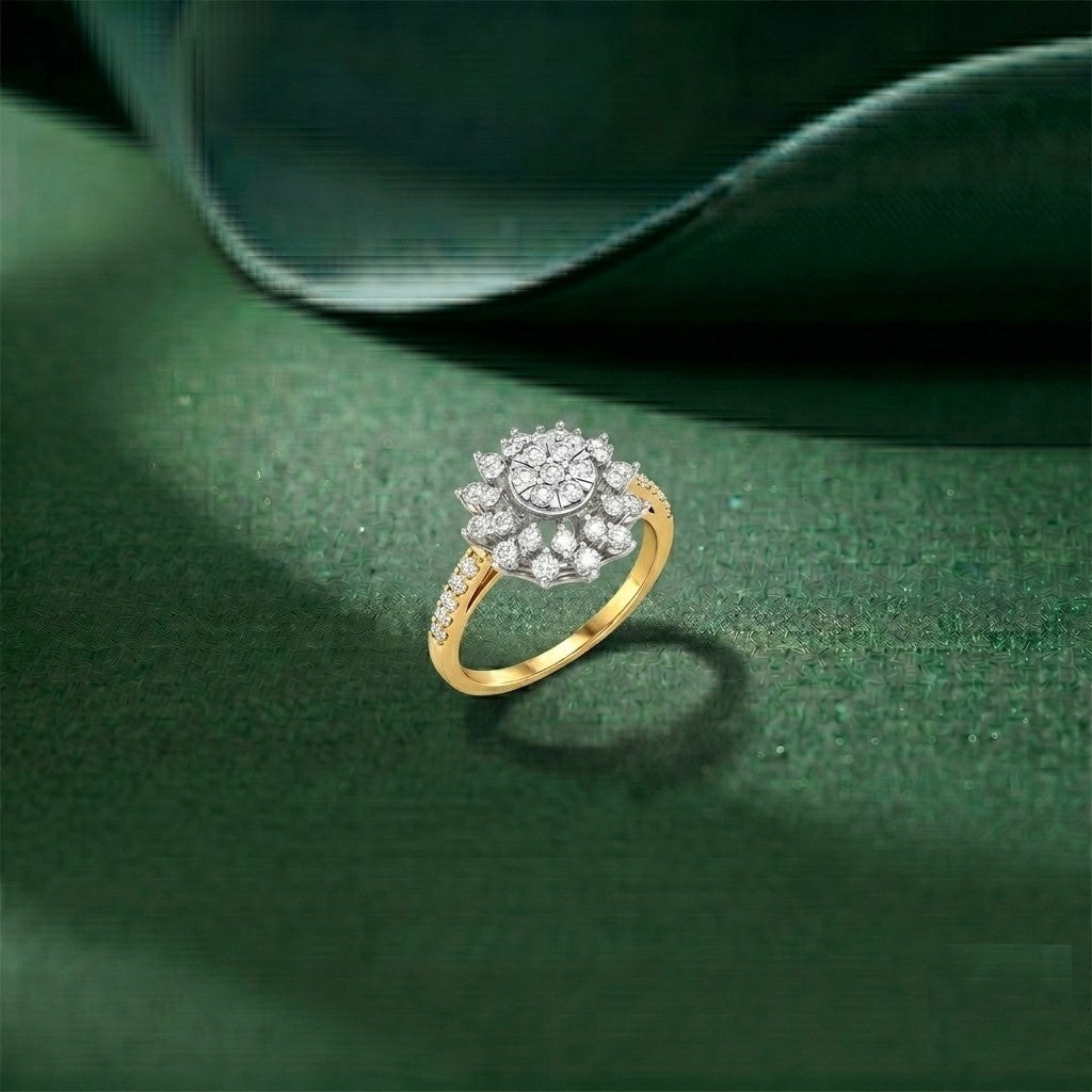 A gold ring with diamond floral cluster center, displayed on a textured dark green surface.