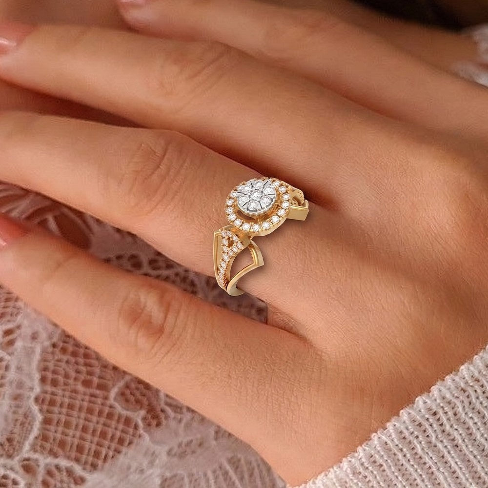 A gold ring with a round design and a curved pavé accent, worn on a person's hand over a white lace fabric.
