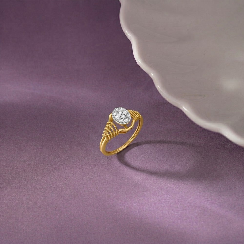 Gold ring with a diamond on a purple surface.