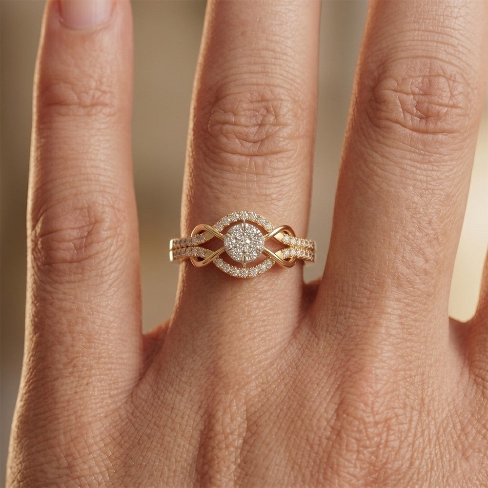 Gold ring with diamond-like stones on a finger against a neutral background.