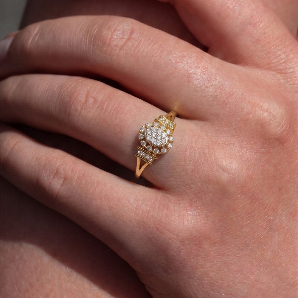 Gold ring with diamonds on a person's finger