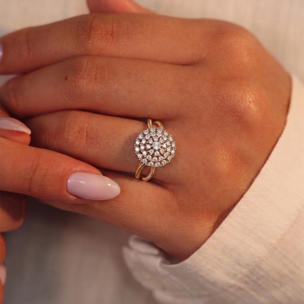 Close-up of a hand wearing a diamond ring with a plain background