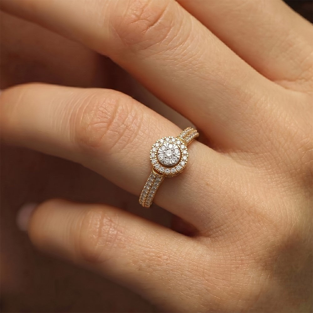Rose gold ring with a diamond on a person's finger.