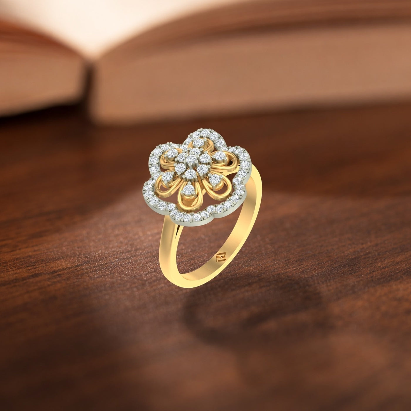 A gold and diamond flower-shaped ring, shown on a wooden surface. 