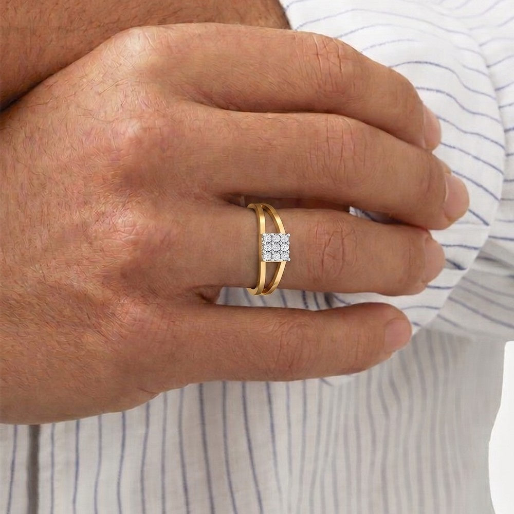 Hand wearing a gold ring with a diamond on a striped fabric background.