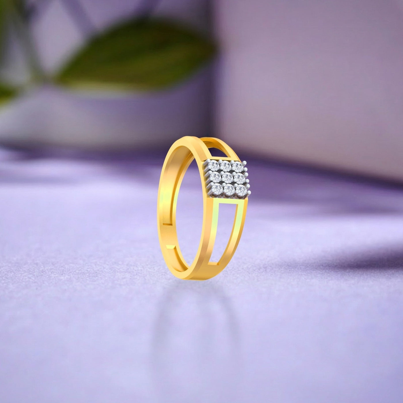 Gold and diamond ring with square cluster diamond on a blue surface.