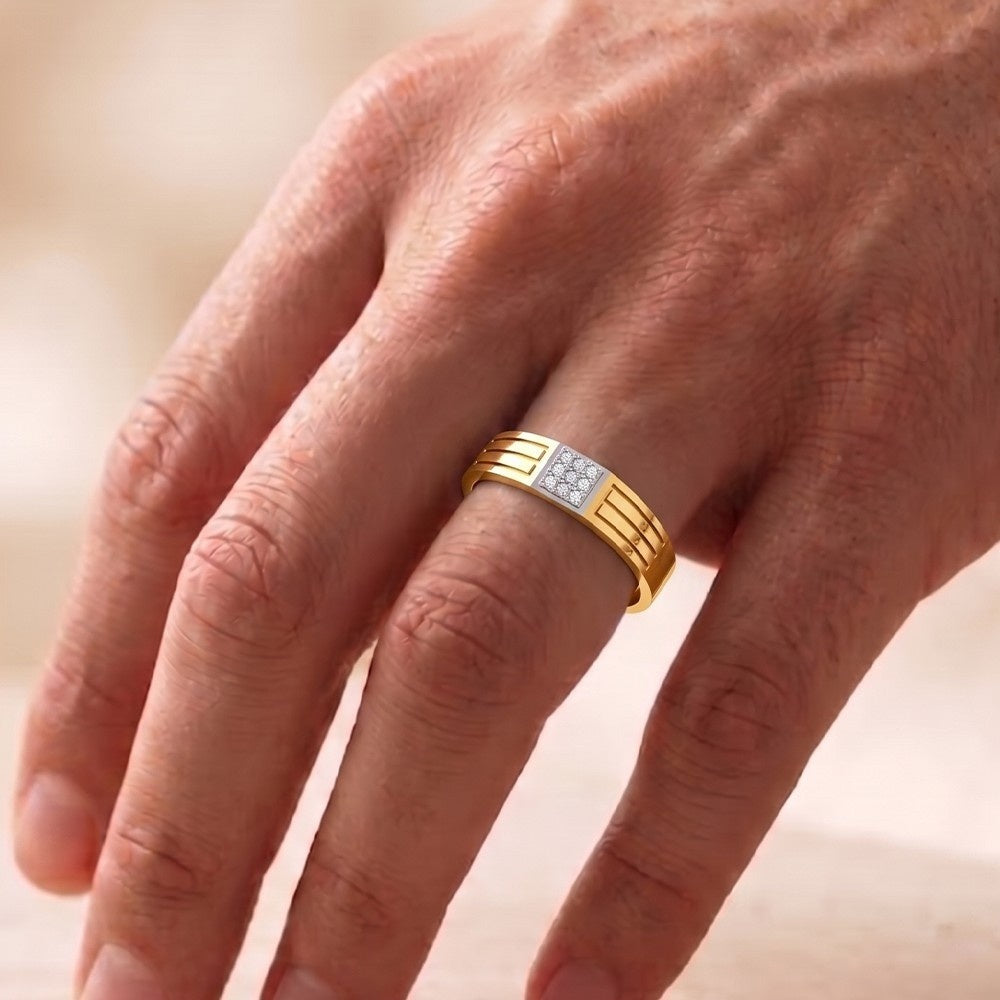 A close-up of a hand wearing a gold and diamond band ring.