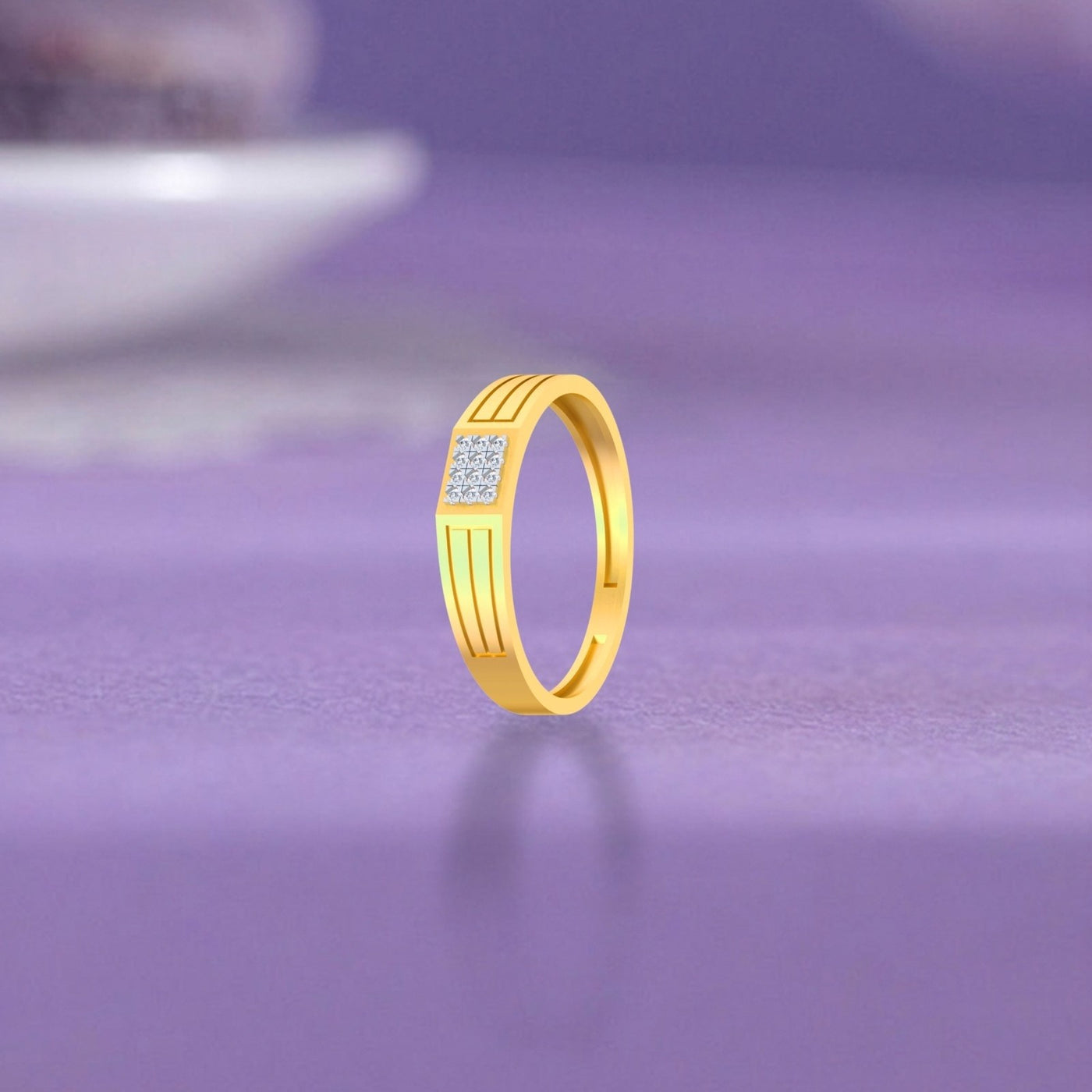 Gold ring with diamonds on a purple surface.