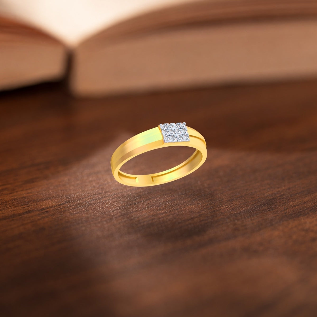 Gold ring with a diamond on a wooden surface.