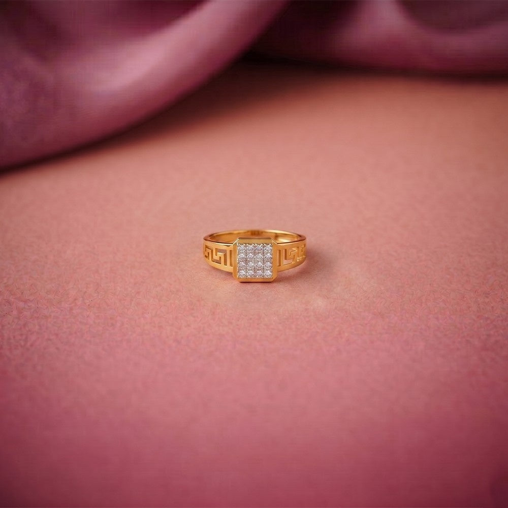 Gold ring with embedded diamonds on a pink fabric background.