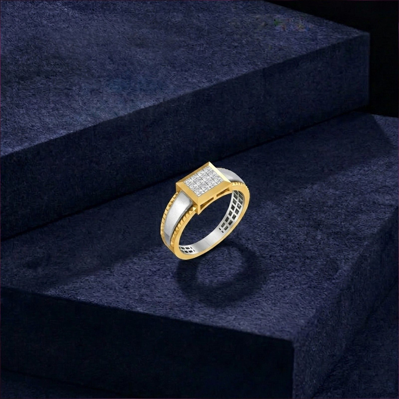 Gold and silver ring on a dark blue textured surface.