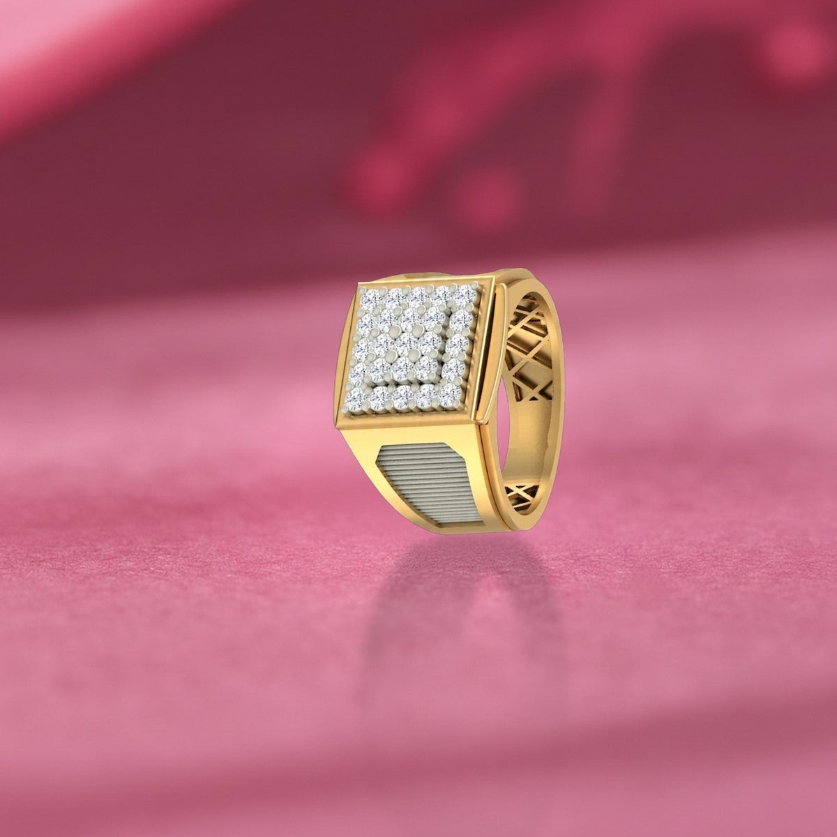 Gold ring with diamond accents on a pink fabric background