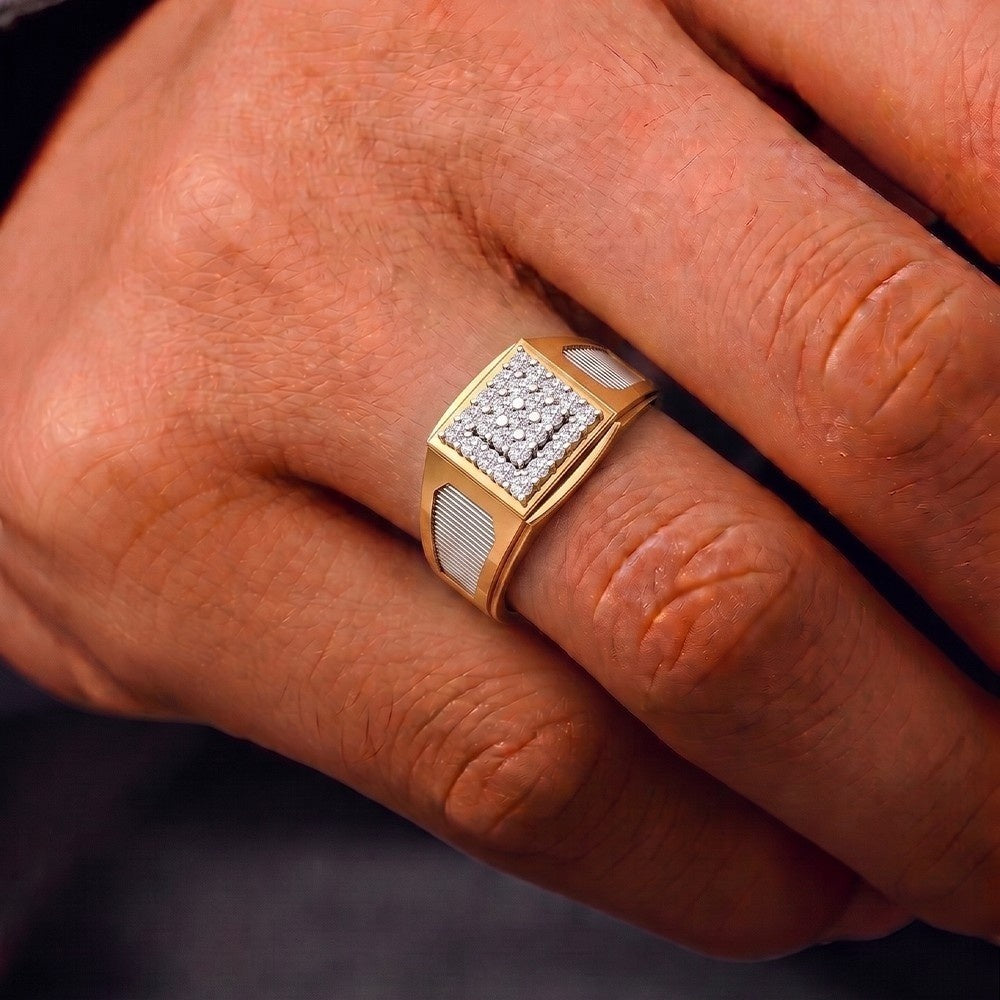 Gold ring with diamonds on a person's finger against a dark background