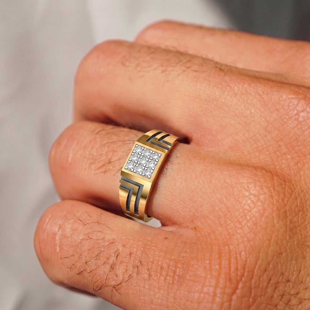 A close-up of a gold band ring with a square face set, worn on a person's finger.