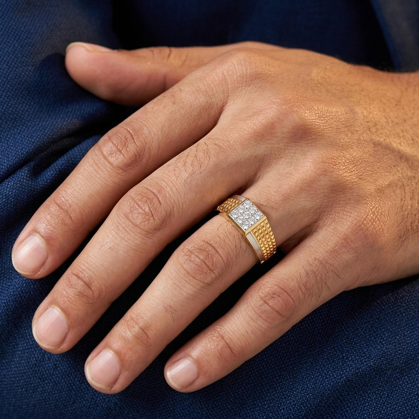 Gold ring with a diamond on a person's finger against a blurred background.