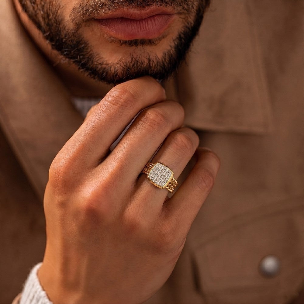 Close-up of a hand wearing a gold ring with a blurred background