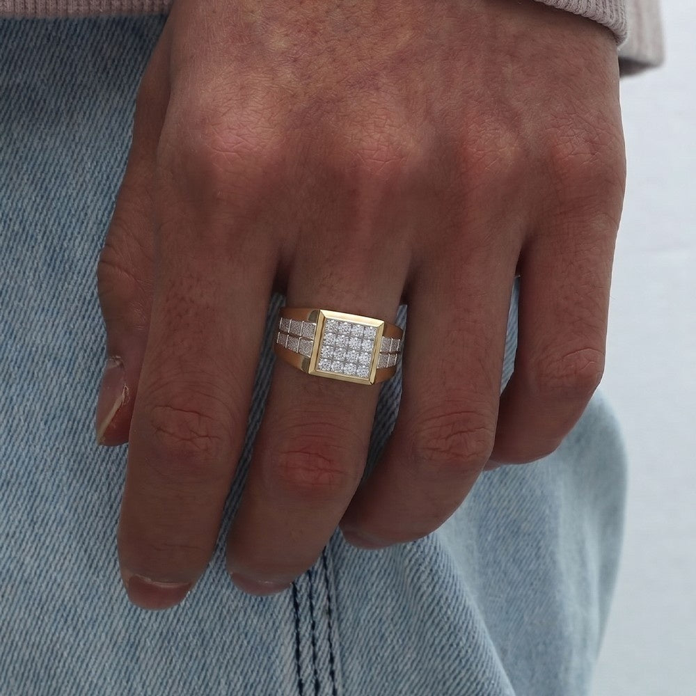 Hand wearing a gold ring with diamonds on a denim background