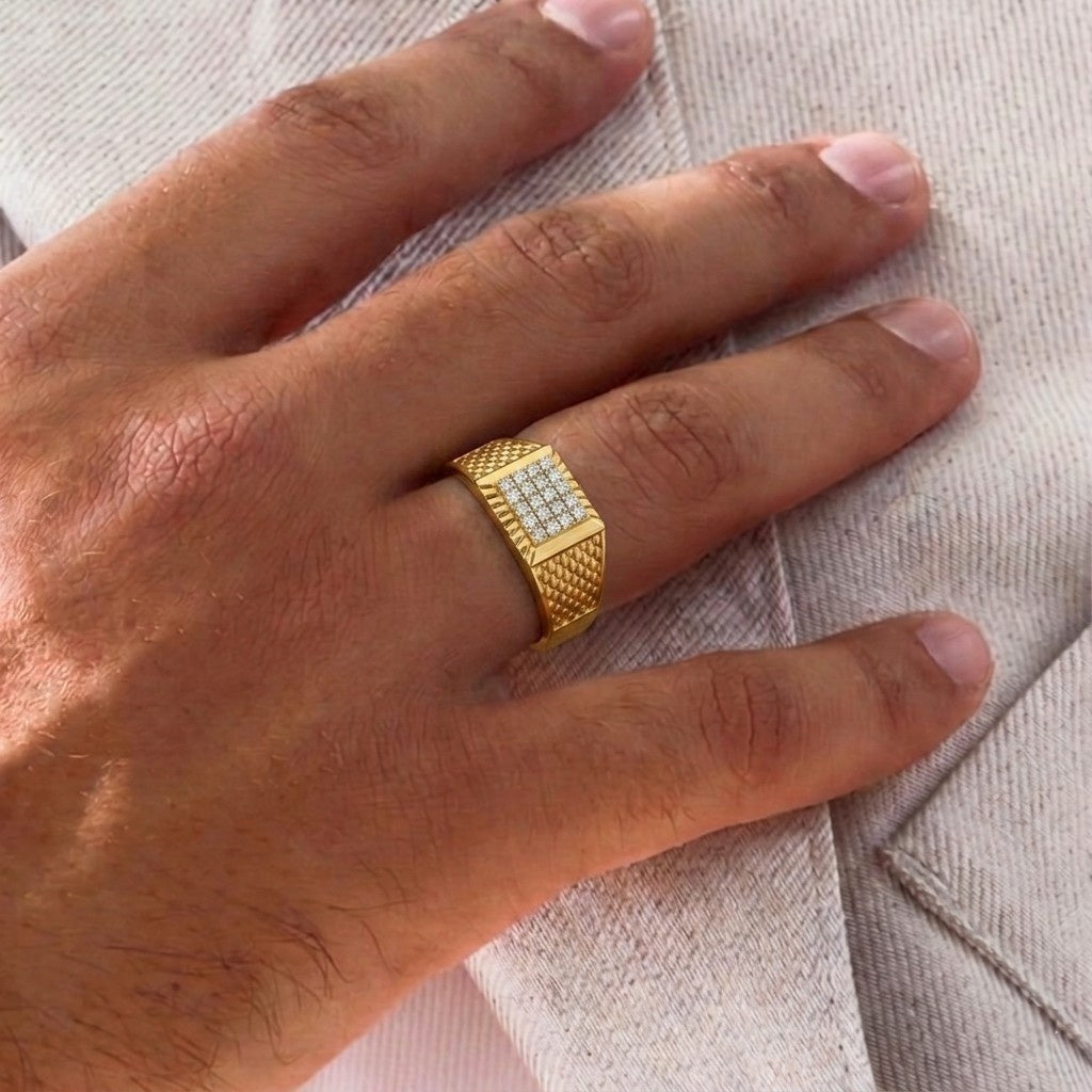 Gold ring with diamond accents on a person's finger against a neutral background