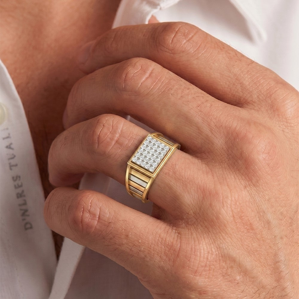 A close-up of a man's hand wearing a gold ring with a square, against a white shirt background.
