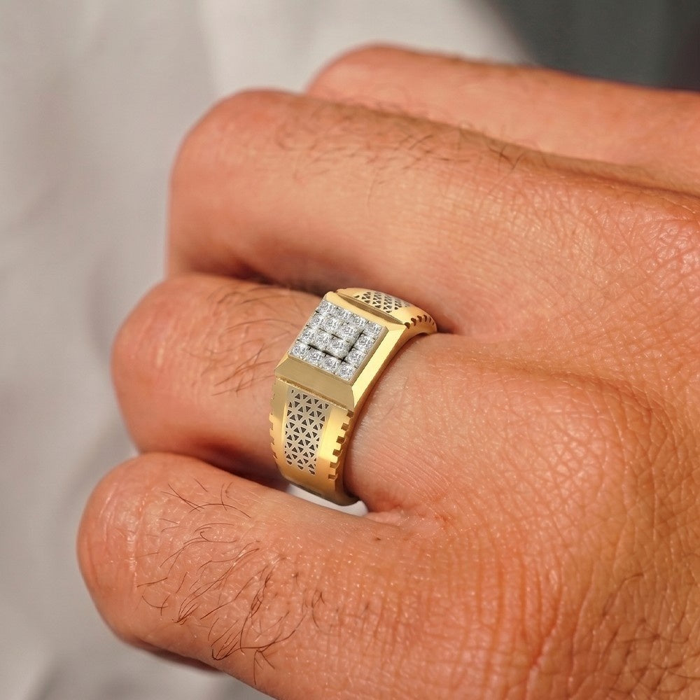 Gold ring with diamonds on a person's finger against a neutral background