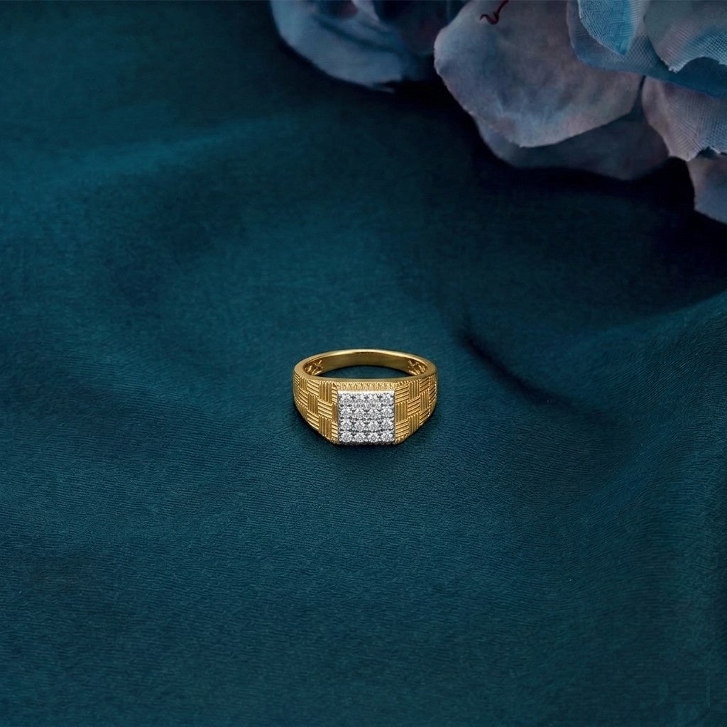 Gold ring with diamonds on a textured blue surface.