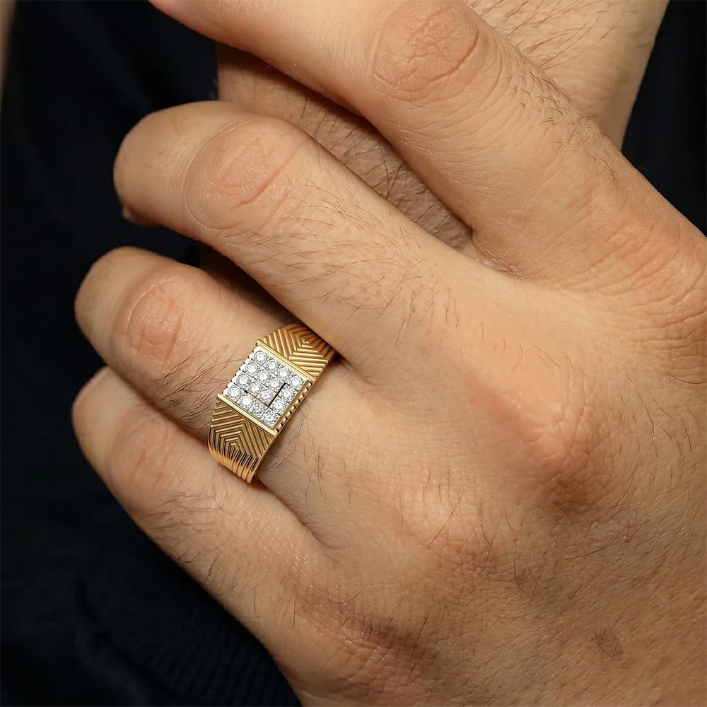 Gold ring with diamond accents on a hand against a dark background