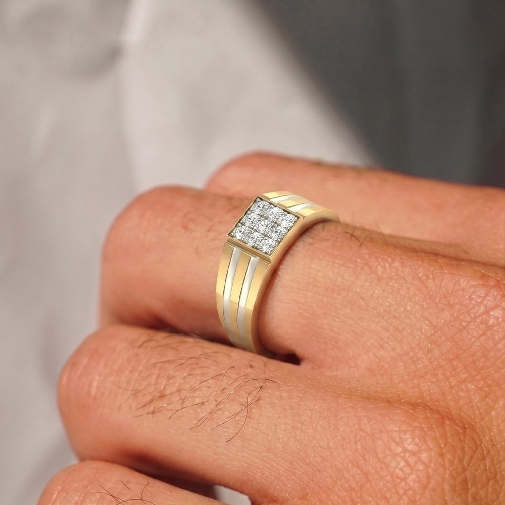 Gold ring with diamonds on a person's finger against a neutral background