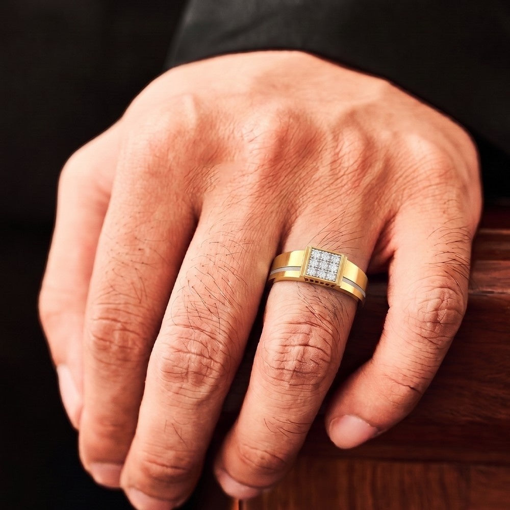 Hand wearing a gold ring with a diamond band on a wooden surface