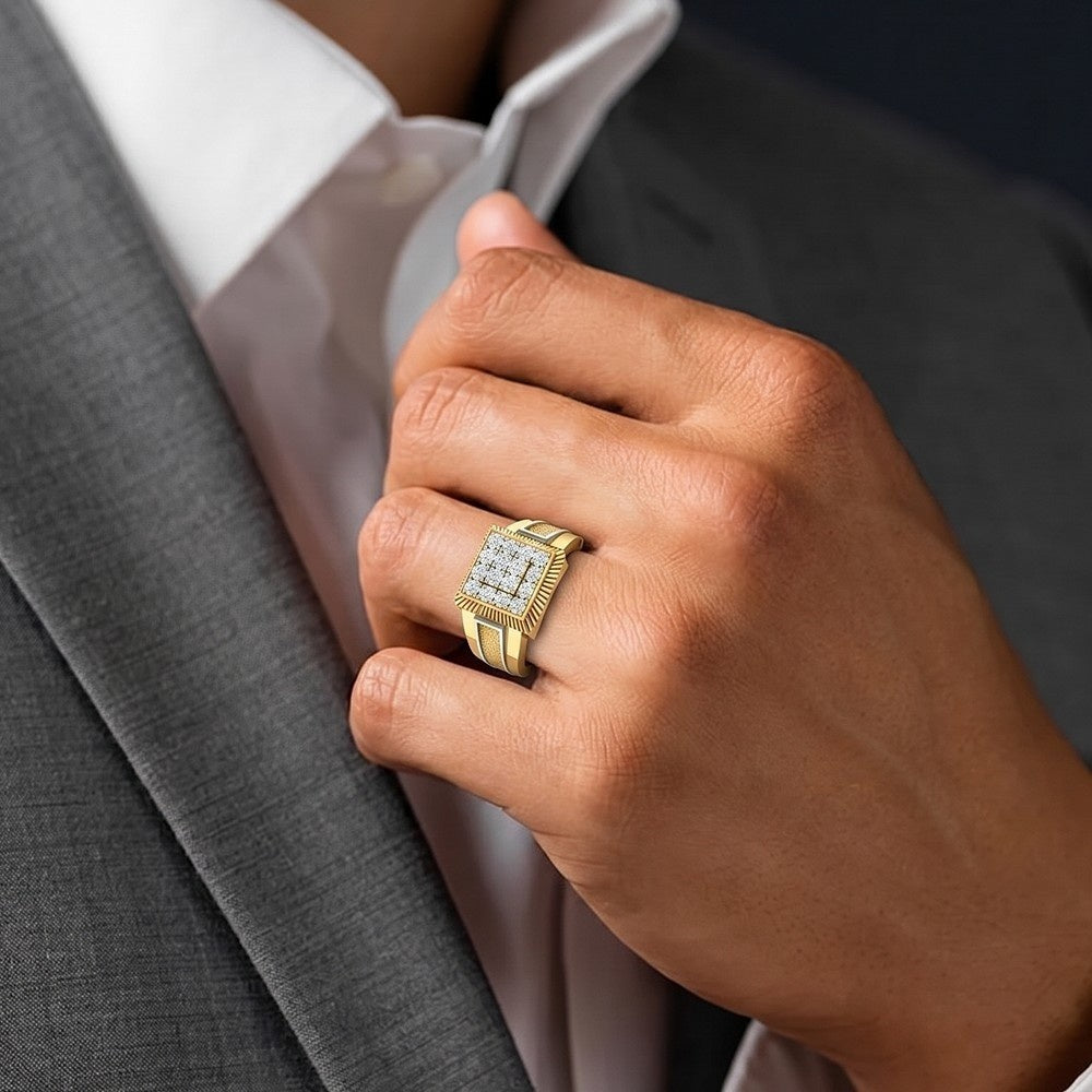 Hand wearing a gold ring with a diamond setting, against a gray suit background