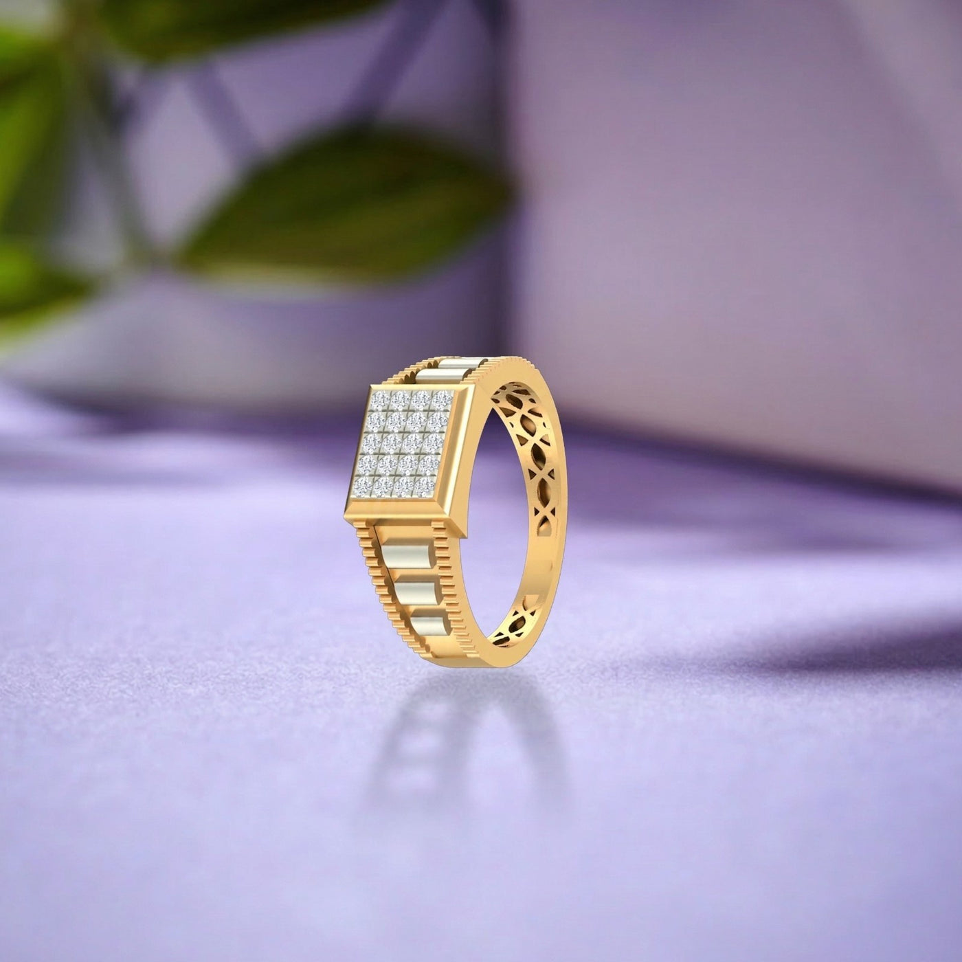 A gold ring with a rectangular face paved, shown on a soft lavender surface with a blurred background.