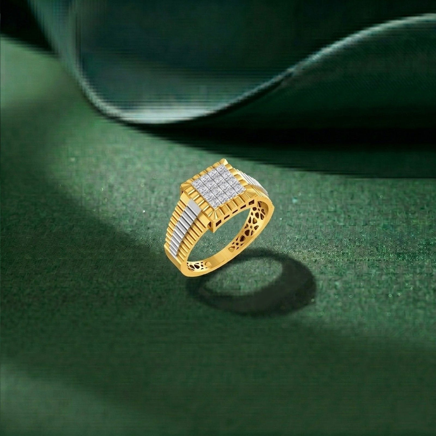 Gold ring with diamond accents on a green textured surface