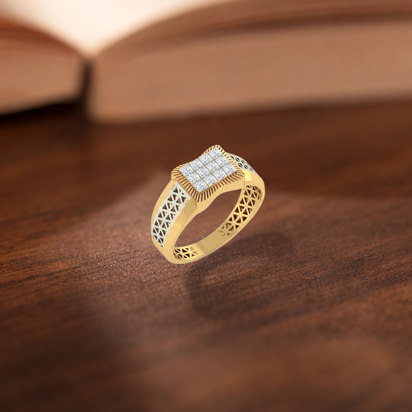 A gold ring with a square diamond-studded face and intricate filigree detailing on the band, resting on a dark wooden surface.