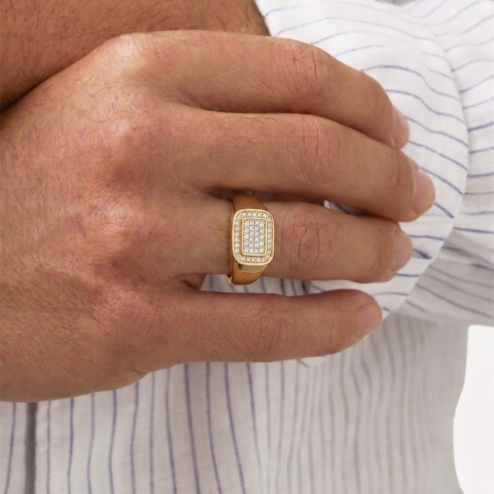 Gold ring with diamonds on a person's finger against a striped shirt background