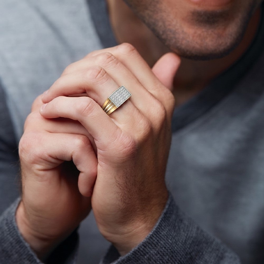 Close-up of a person wearing a gold ring with a diamond band.
