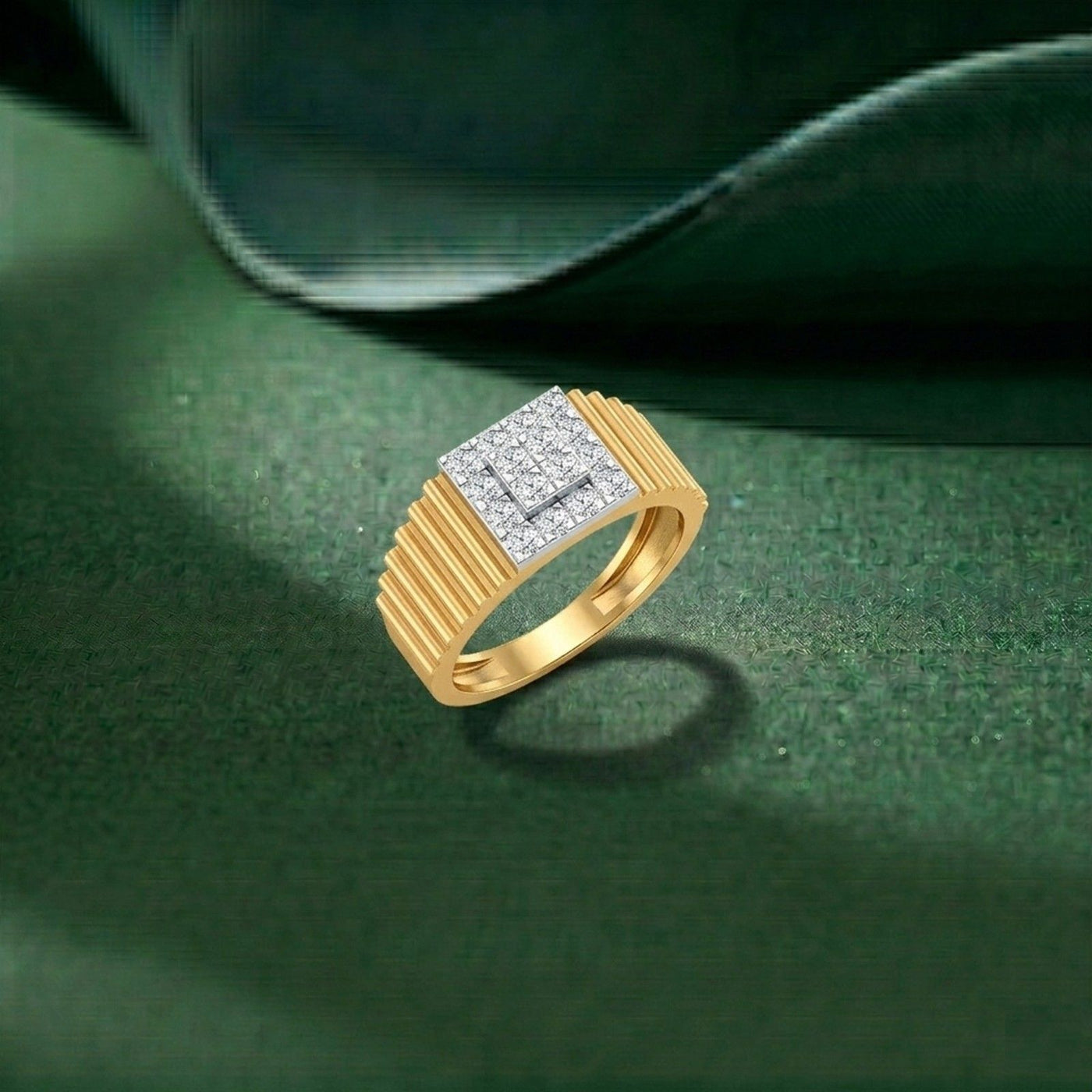 Gold ring with diamond accents on a green surface